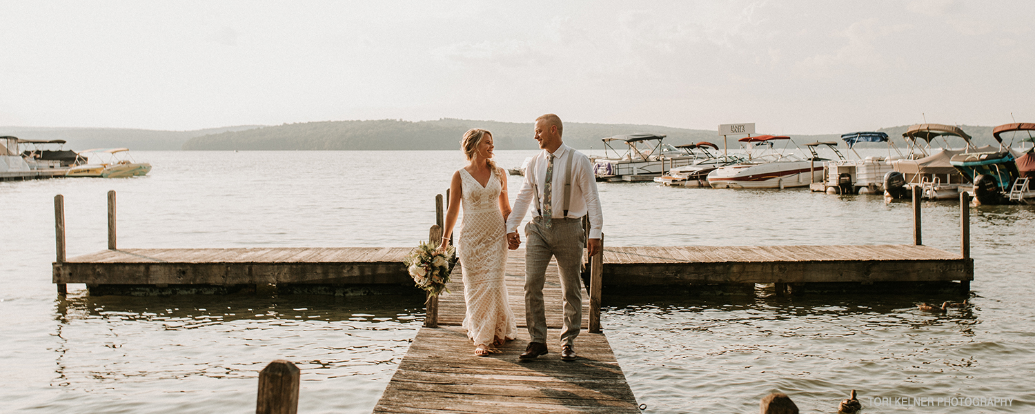 Wedding couple on dock at Silver Birches